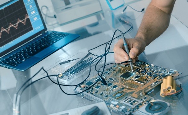 Engineer testing an electronic circuit board